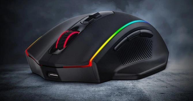 A black Redragon M686 Vampire Elite wireless gaming mouse rests on a textured gray surface against a dark, smoky background. The mouse features vibrant RGB lighting accents along its edges and around the scroll wheel.