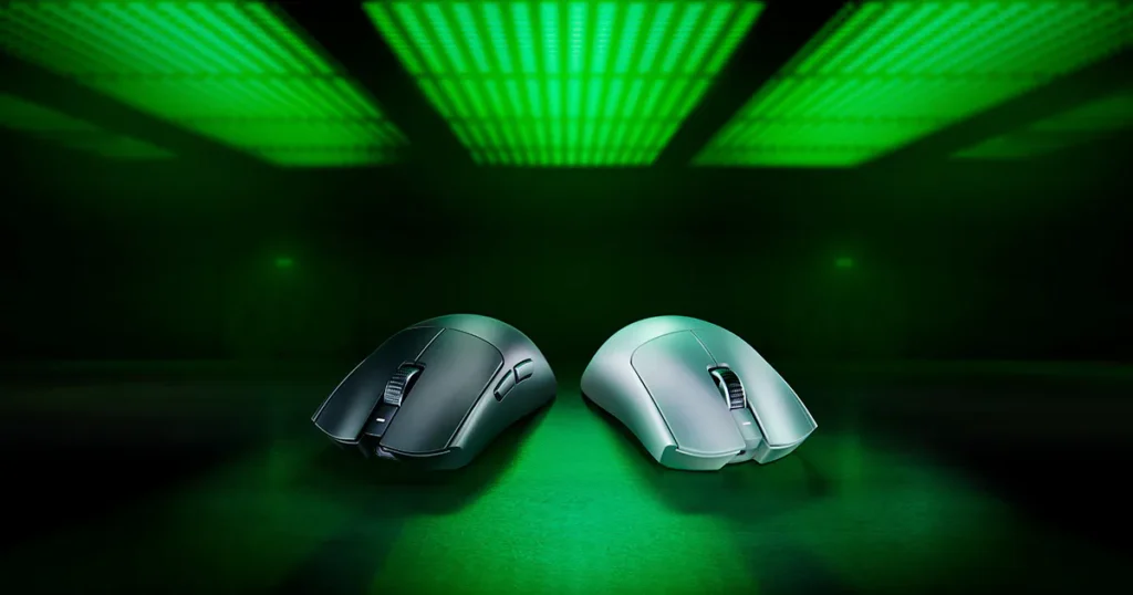 Two Razer Viper V3 Pro wireless gaming mice, one black and one white, are positioned against a dark green backdrop with bright green lighting.