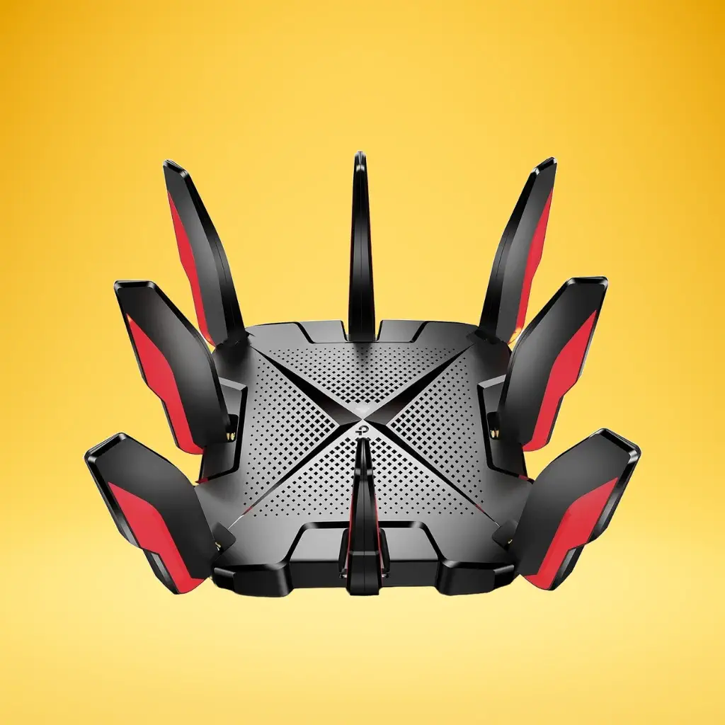 A top-down view of the TP-Link Archer GX90, a black gaming router with red accents, featuring eight external antennas arranged around a central, X-shaped vent pattern, set against a bright yellow background.